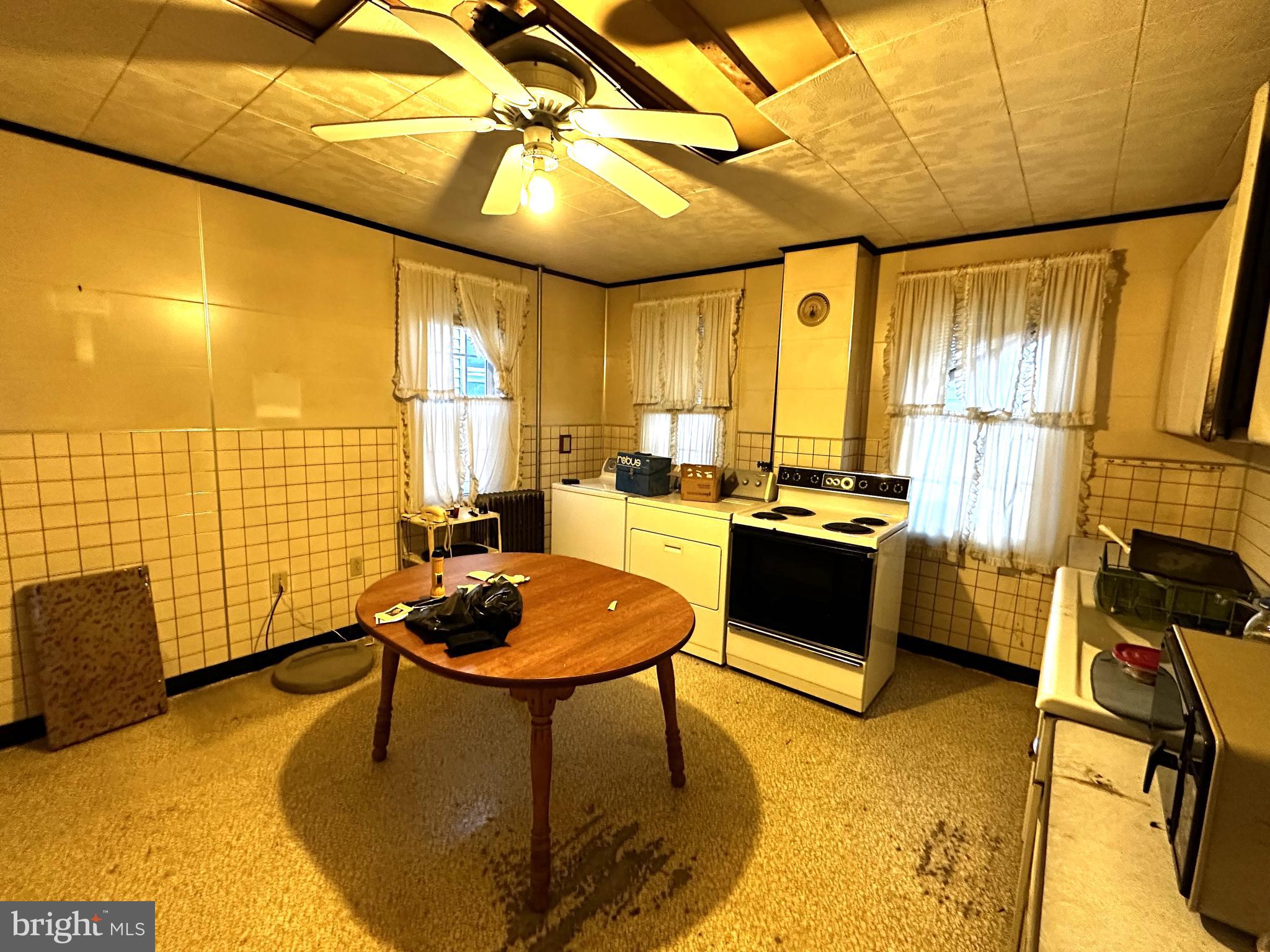 239 East Hazard Street Summit Hill, PA 18250 - Photo 10 of 39 a kitchen with a table chairs stove and refrigerator