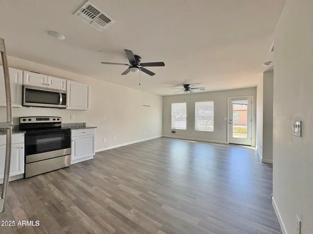 a view of kitchen with stove and microwave