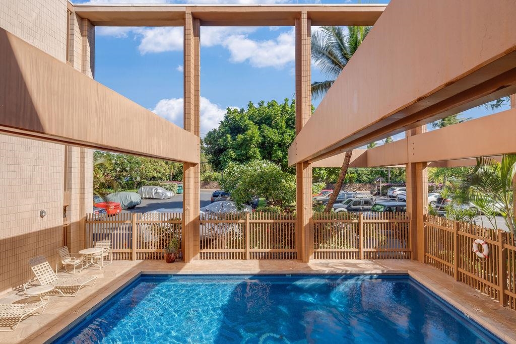 3785 Lower Honoapiilani Road, Unit 208 Lahaina, HI 96761 - Photo 40 of 50 a living room with wooden floor and a table