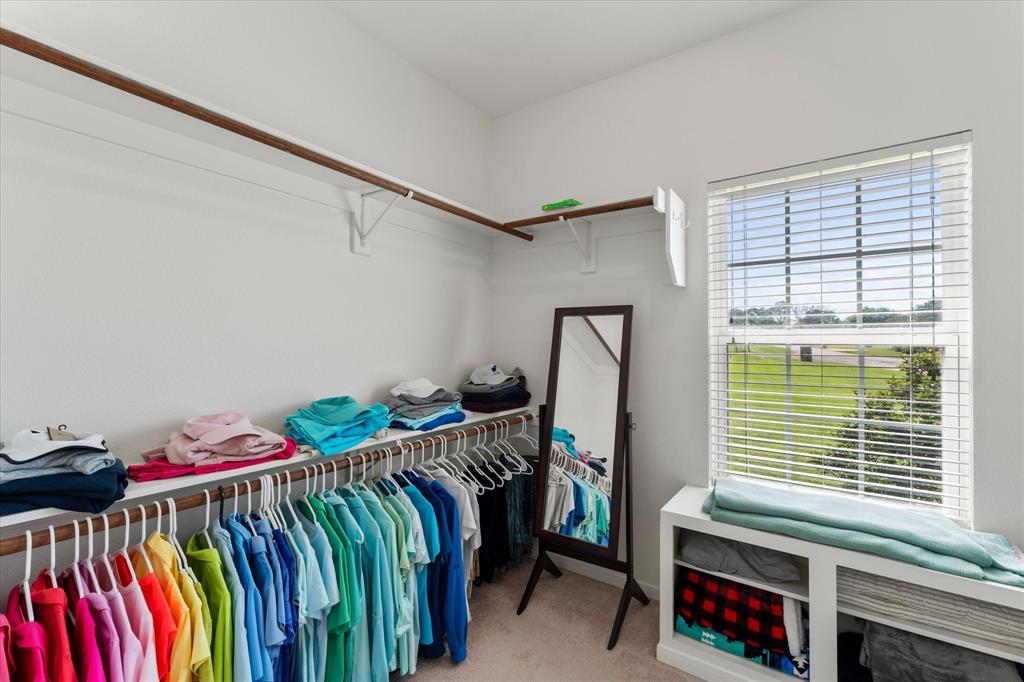 345 Rains County Road 3390 Emory, TX 75440 - Photo 28 of 39 a bedroom with a bed and a chandelier