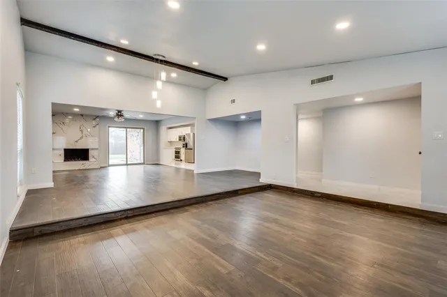 an empty room with wooden floor