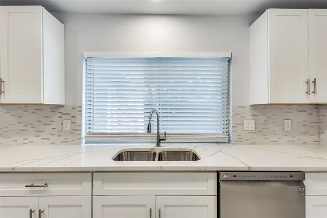 a kitchen with a sink and cabinets