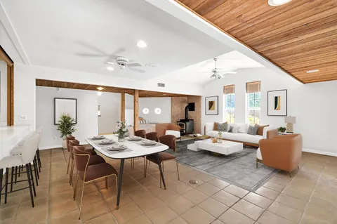 a view of an empty room with closet and a window