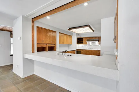 a view of an empty room with a ceiling fan
