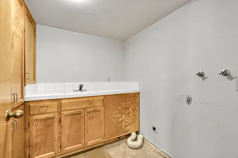 a view of patio with wooden stairs and a table and chairs under an umbrella