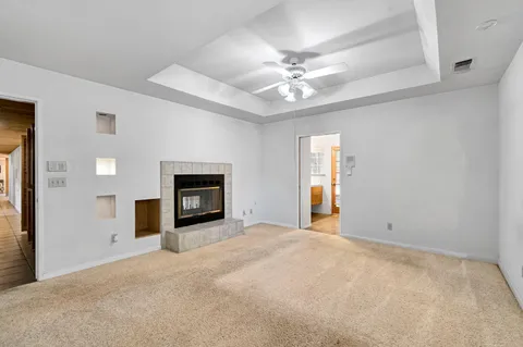 an aerial view of a house with a yard and trees all around