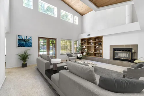 a view of an empty room with a fireplace and a window