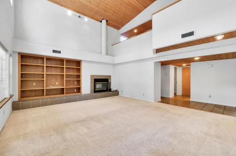 a spacious bedroom with a bed and a window