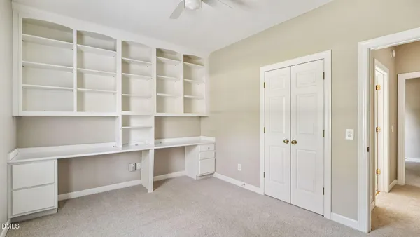a view of an empty room with a closet