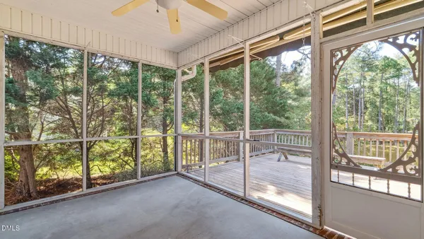 a view of a room with wooden floor and windows
