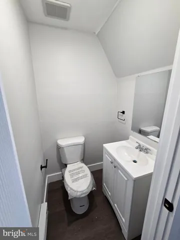a bathroom with a sink mirror and toilet