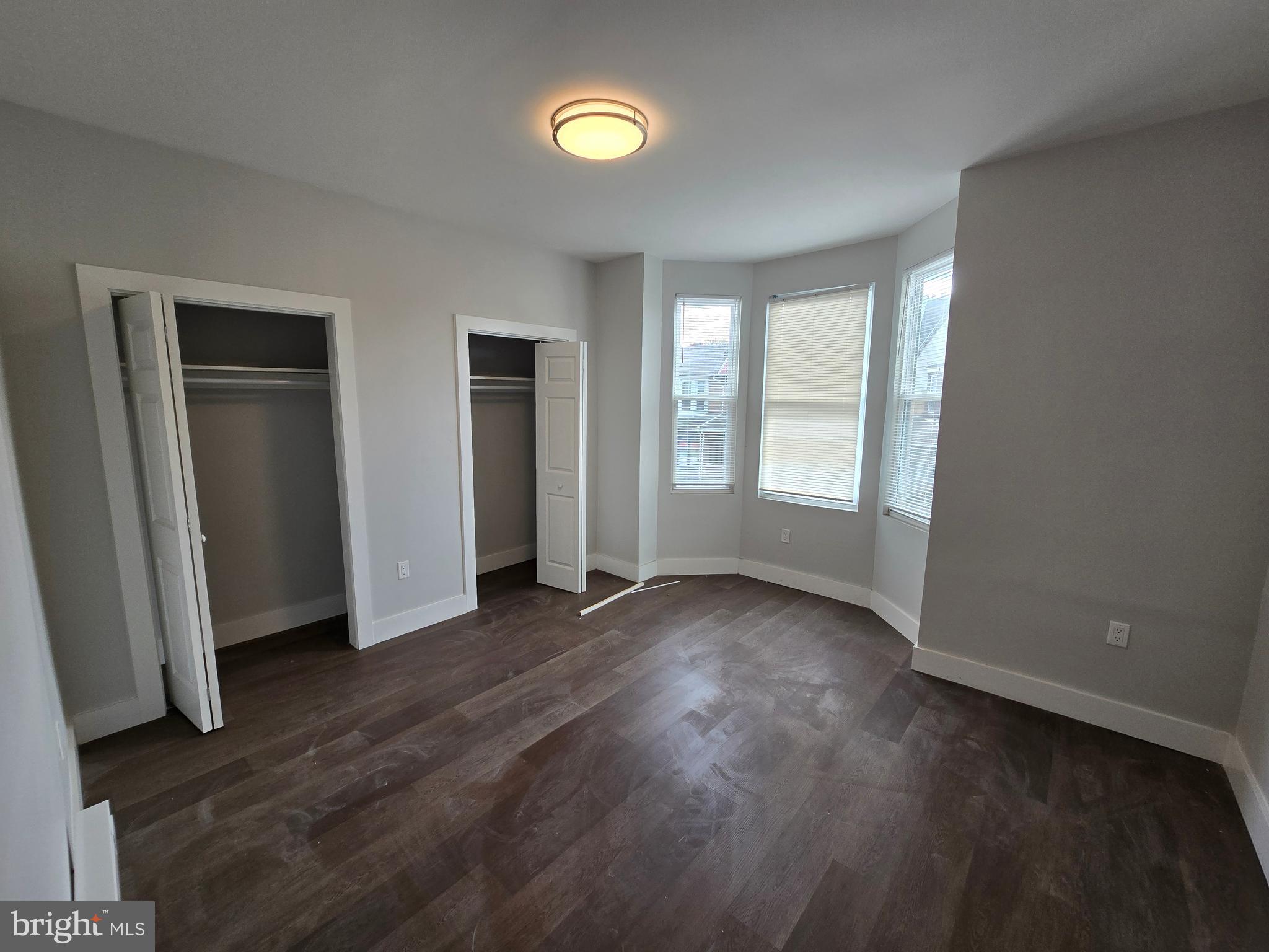 1321 West Wingohocking Street, Unit 2 Philadelphia, PA 19140 - Photo 14 of 26 an empty room with wooden floor and windows