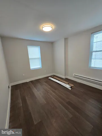 an empty room with wooden floor and closet
