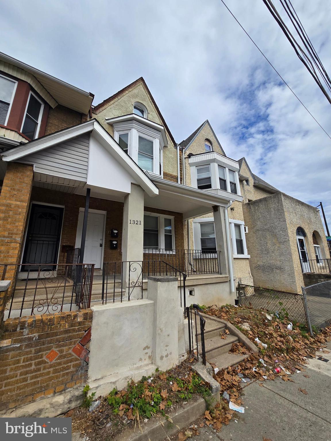 1321 West Wingohocking Street, Unit 2 Philadelphia, PA 19140 - Photo 2 of 26 a front view of a house with many windows