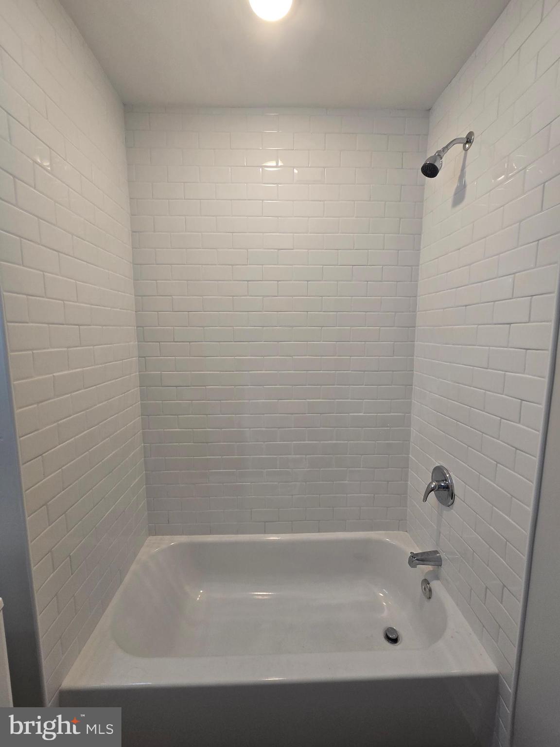 1321 West Wingohocking Street, Unit 2 Philadelphia, PA 19140 - Photo 22 of 26 a close up of a bathtub in a bathroom