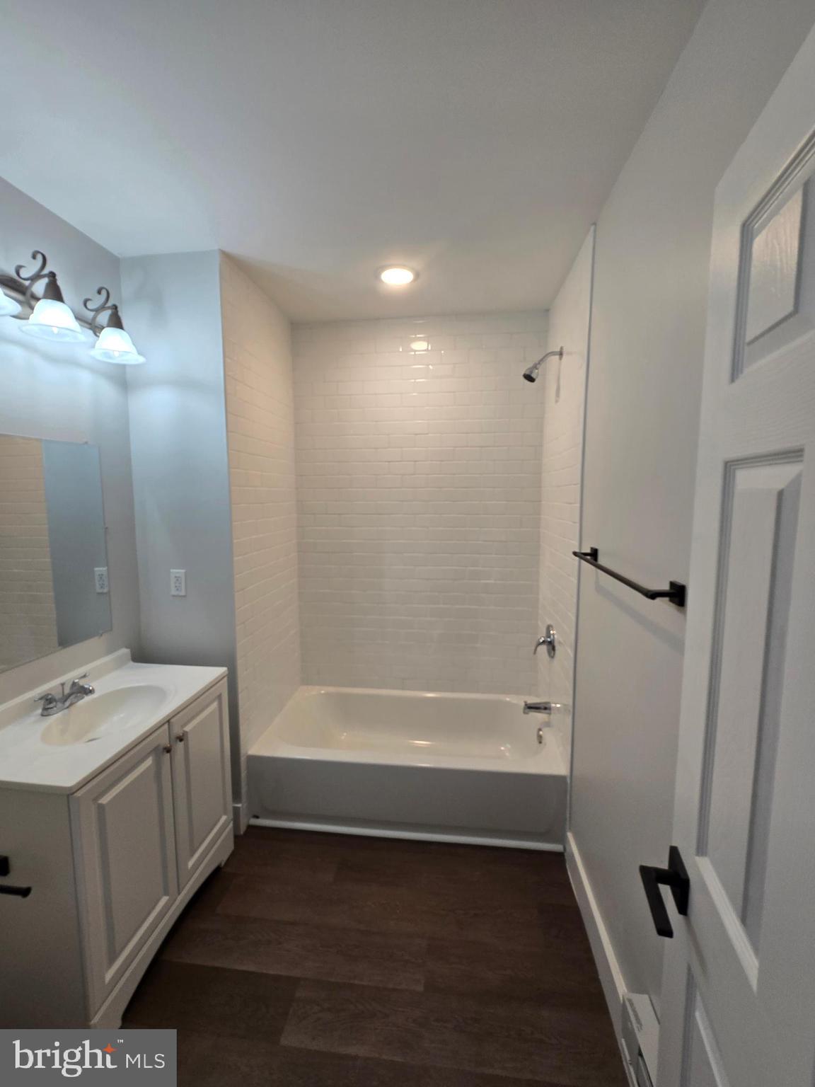 1321 West Wingohocking Street, Unit 2 Philadelphia, PA 19140 - Photo 23 of 26 a bathroom with a bathtub a sink a toilet and a mirror