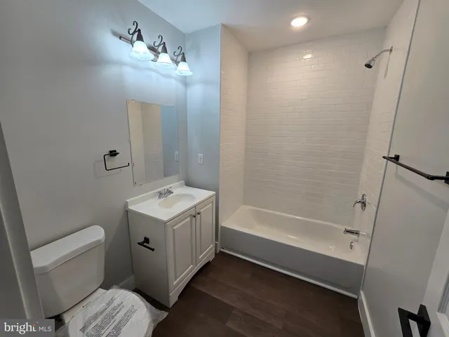 a view of a room with wooden floor and window