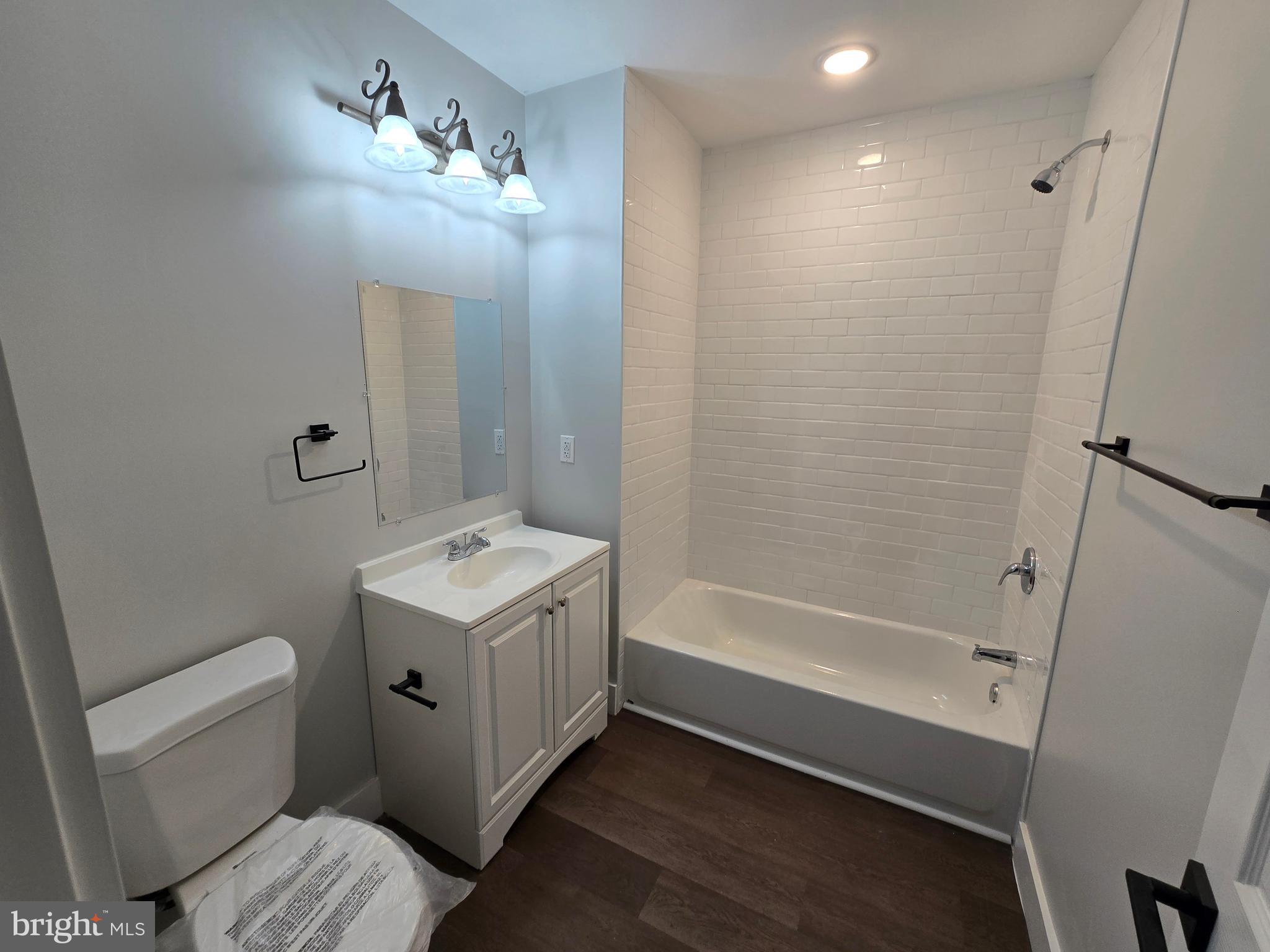 1321 West Wingohocking Street, Unit 2 Philadelphia, PA 19140 - Photo 24 of 26 a bathroom with a sink a toilet and shower