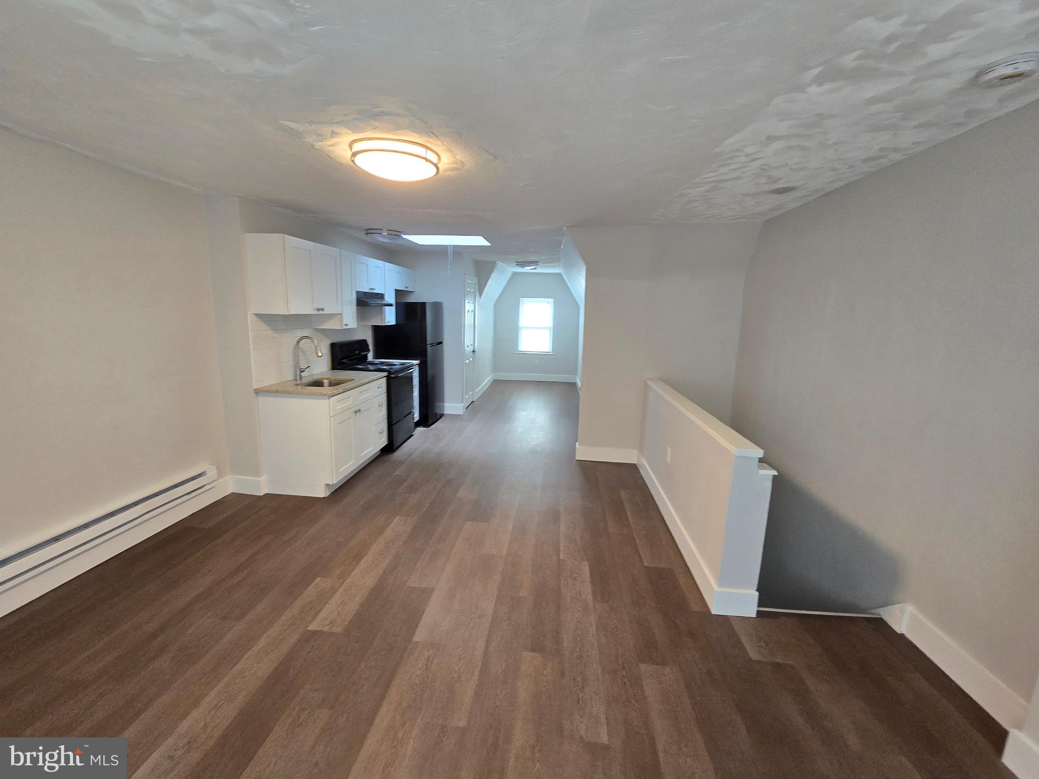 1321 West Wingohocking Street, Unit 2 Philadelphia, PA 19140 - Photo 4 of 26 a view of a kitchen with wooden floor and a sink