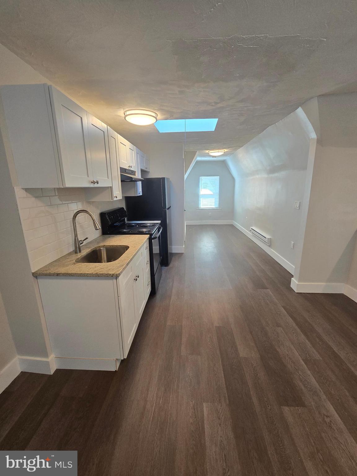 1321 West Wingohocking Street, Unit 2 Philadelphia, PA 19140 - Photo 7 of 26 a view of a kitchen with furniture and wooden floor
