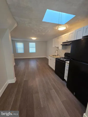 a kitchen with a sink and a refrigerator