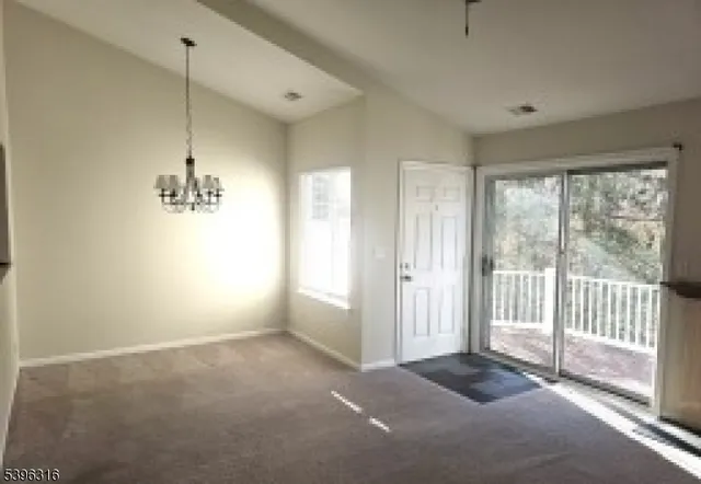 a view of a room with wooden floor and windows