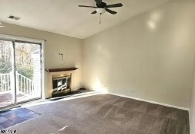 a view of empty room with a fireplace