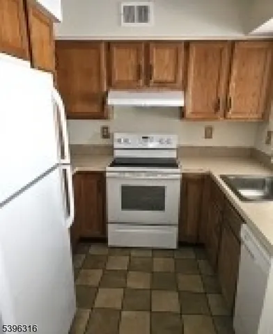 a kitchen with a stove top oven sink and cabinets