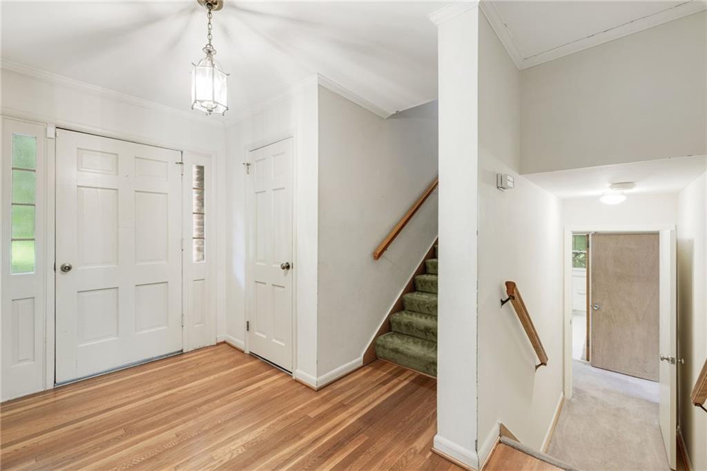 1911 Alderbrook Road Northeast Atlanta, GA 30345 - Photo 5 of 33 a view of a hallway with wooden floor and staircase