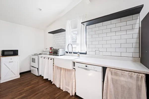 a bedroom with a bed and a refrigerator