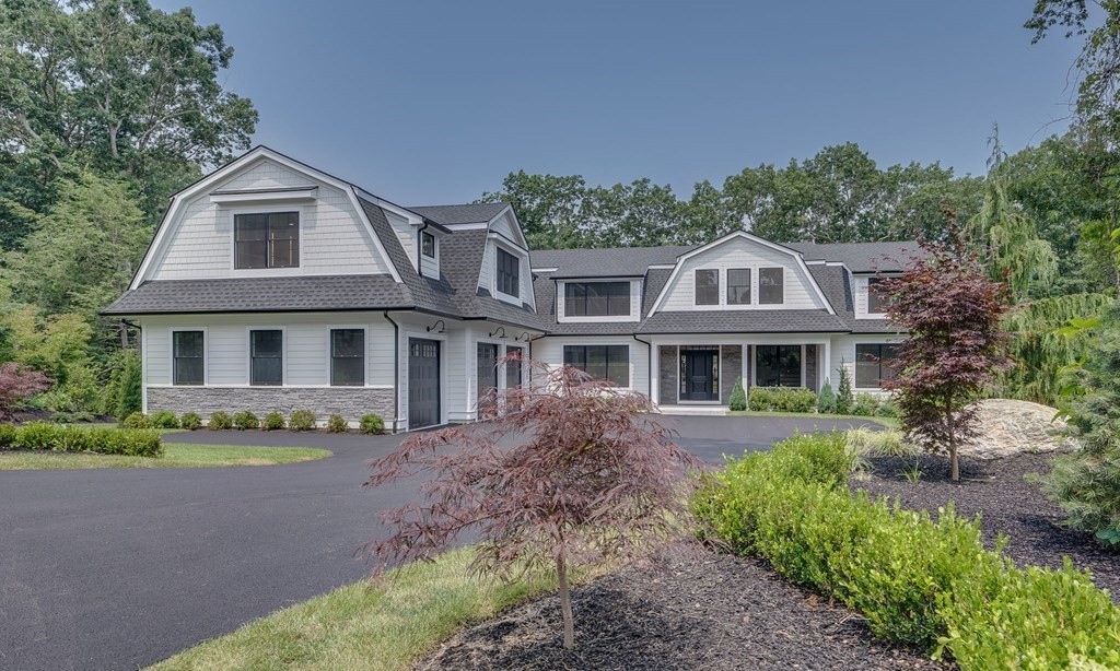 a front view of a house with a garden