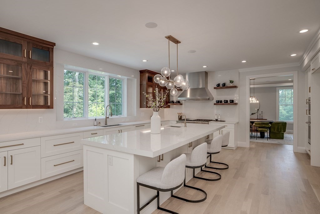 68 Clarke Circle Needham, MA 02492 - Photo 11 of 40 a kitchen with sink cabinets and wooden floor