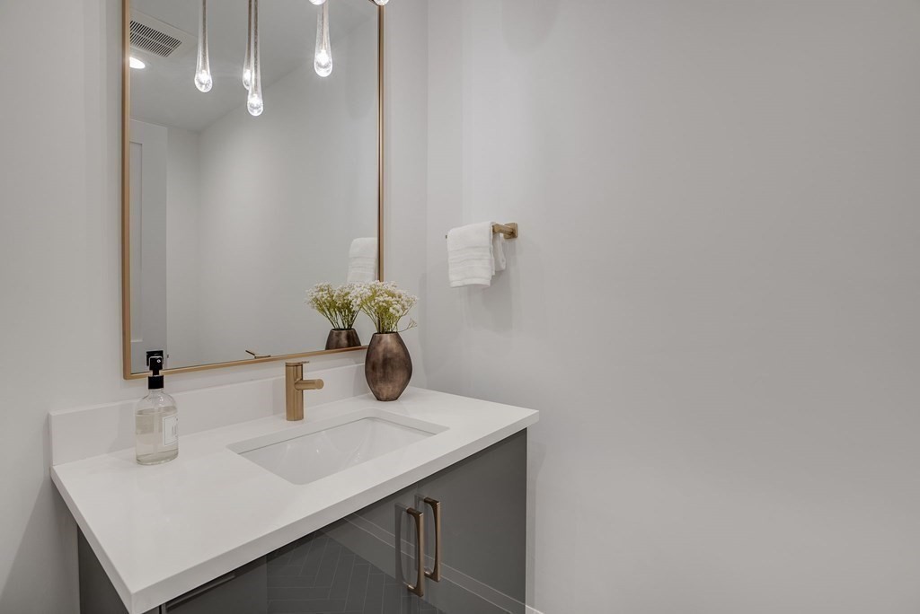 68 Clarke Circle Needham, MA 02492 - Photo 18 of 40 a bathroom with a sink and a mirror