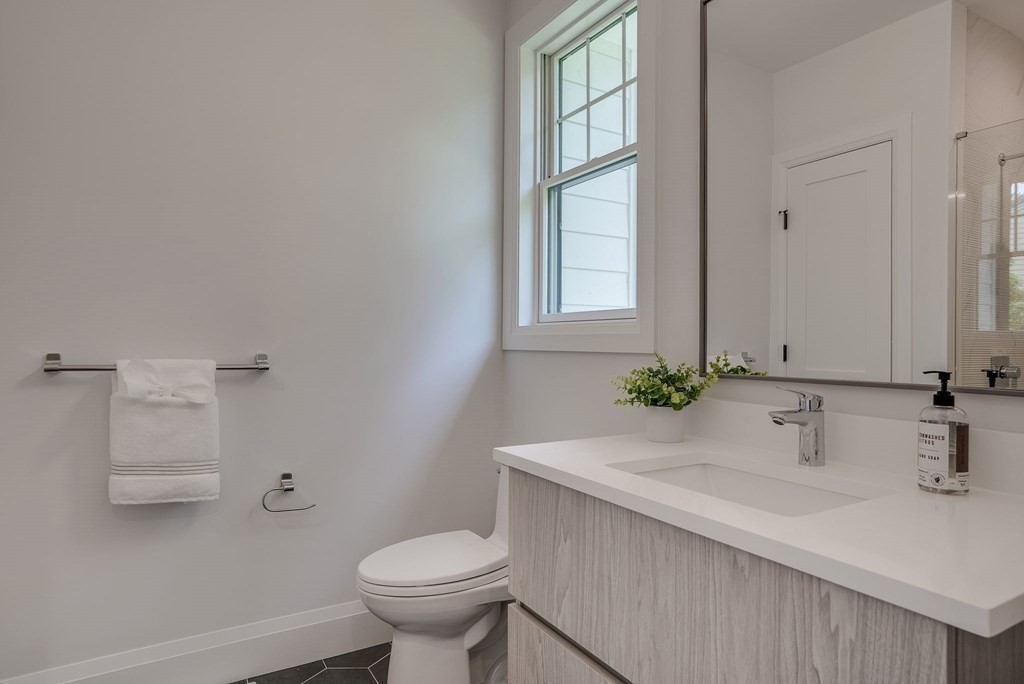 68 Clarke Circle Needham, MA 02492 - Photo 21 of 40 a bathroom with a sink toilet and window