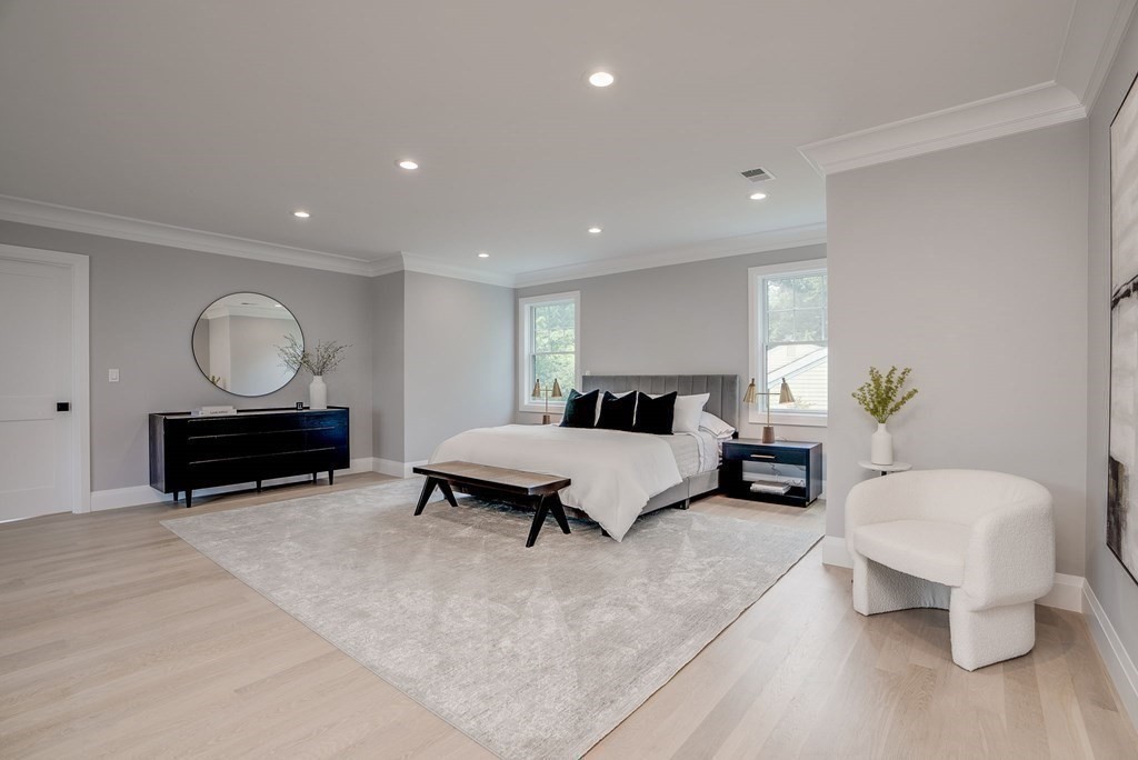 68 Clarke Circle Needham, MA 02492 - Photo 24 of 40 a spacious bedroom with a bed and a couch