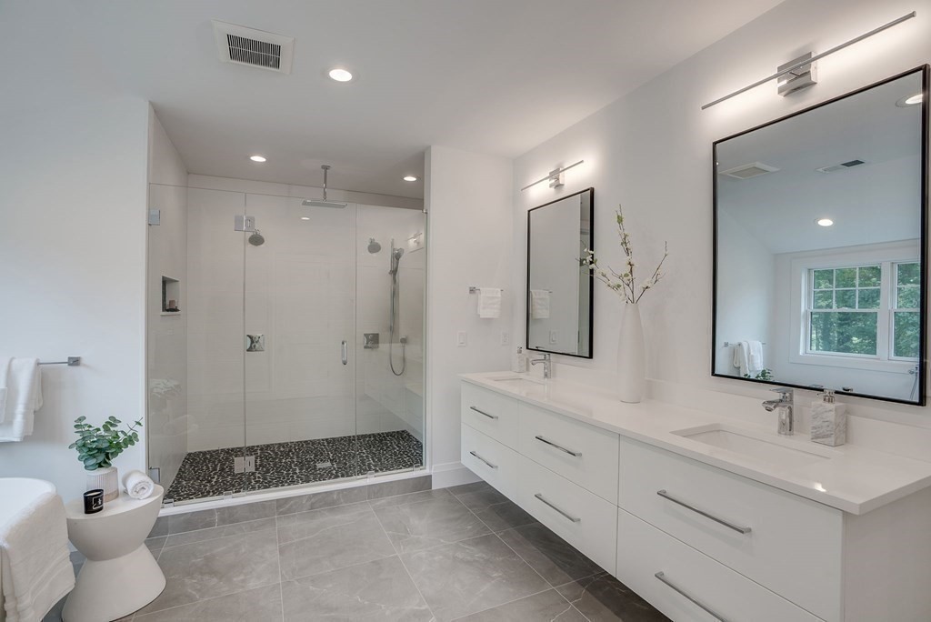 68 Clarke Circle Needham, MA 02492 - Photo 29 of 40 a bathroom with a double vanity sink and a mirror