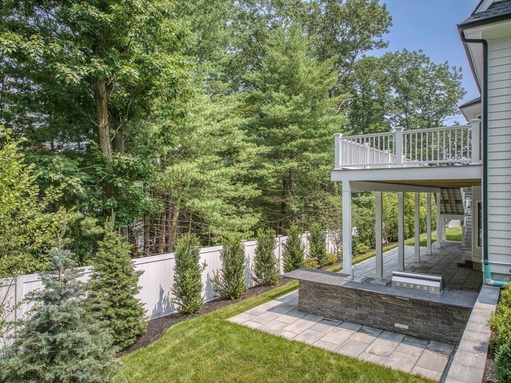 68 Clarke Circle Needham, MA 02492 - Photo 37 of 40 a view of a patio with table and chairs potted plants and large tree