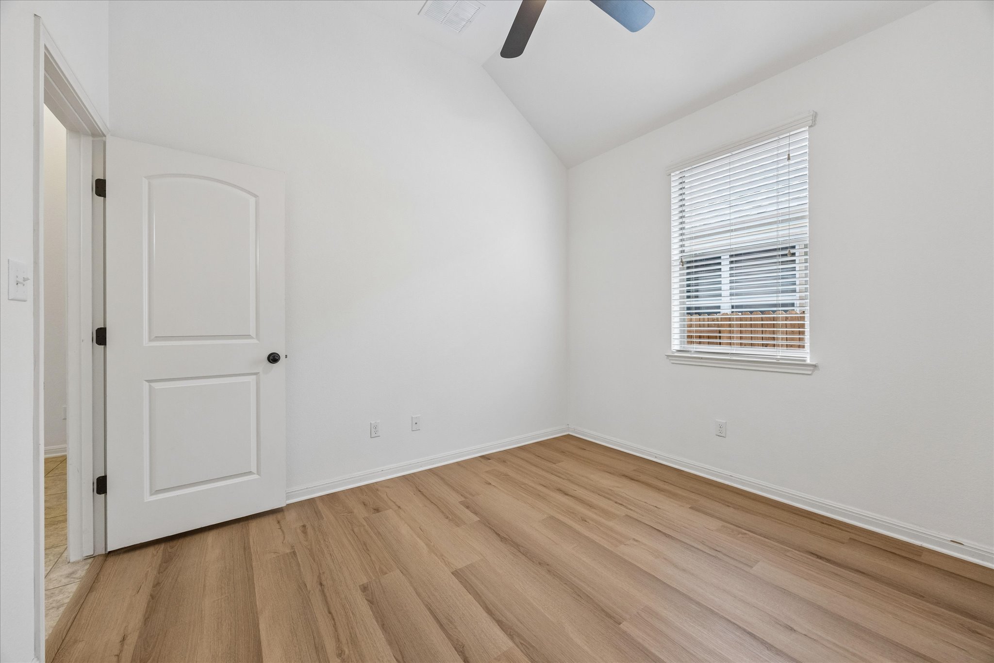 14304 Senia Bend Austin, TX 78738 - Photo 13 of 15 Secondary bedroom features vaulted ceilings and new flooring (June 2026)