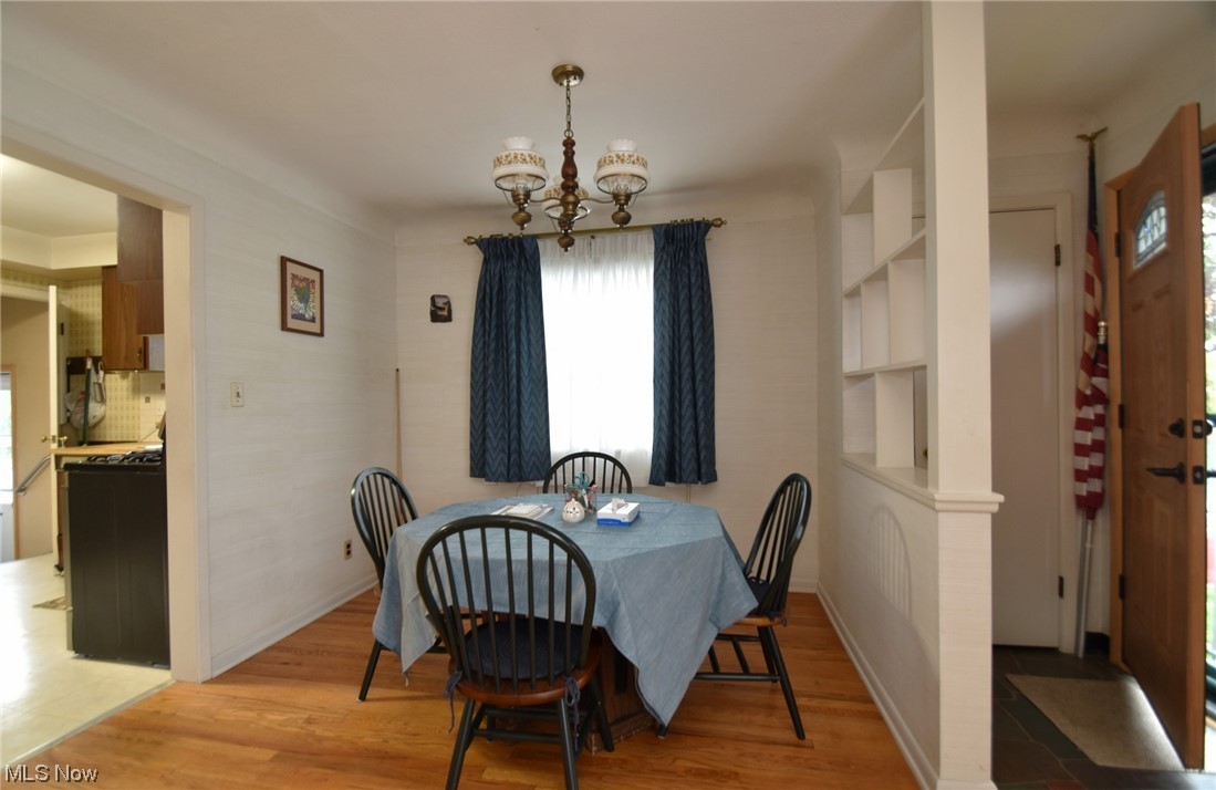 28740 Forest Road Willowick, OH 44095 - Photo 3 of 27 Wood floored dining space with built in shelves and a chandelier