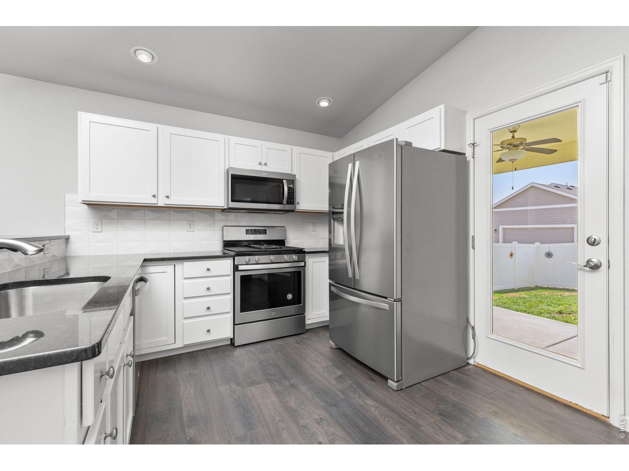 4231 Sunflower Road Evans, CO 80620 - Photo 18 of 29 Kitchen with access to covered back porch and private backyard