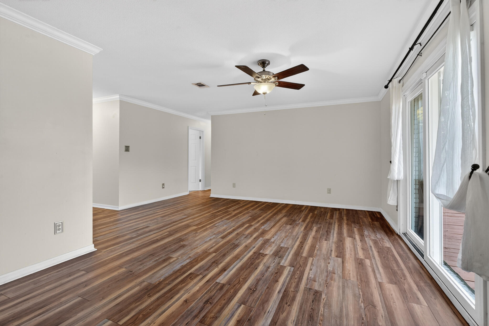 9 Walnut Avenue Shalimar, FL 32579 - Photo 14 of 61 a view of a room with wooden floor and ceiling fan