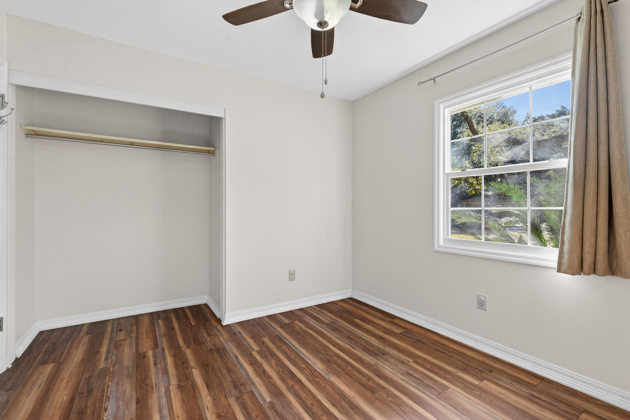 9 Walnut Avenue Shalimar, FL 32579 - Photo 17 of 61 a view of an empty room with wooden floor and a window