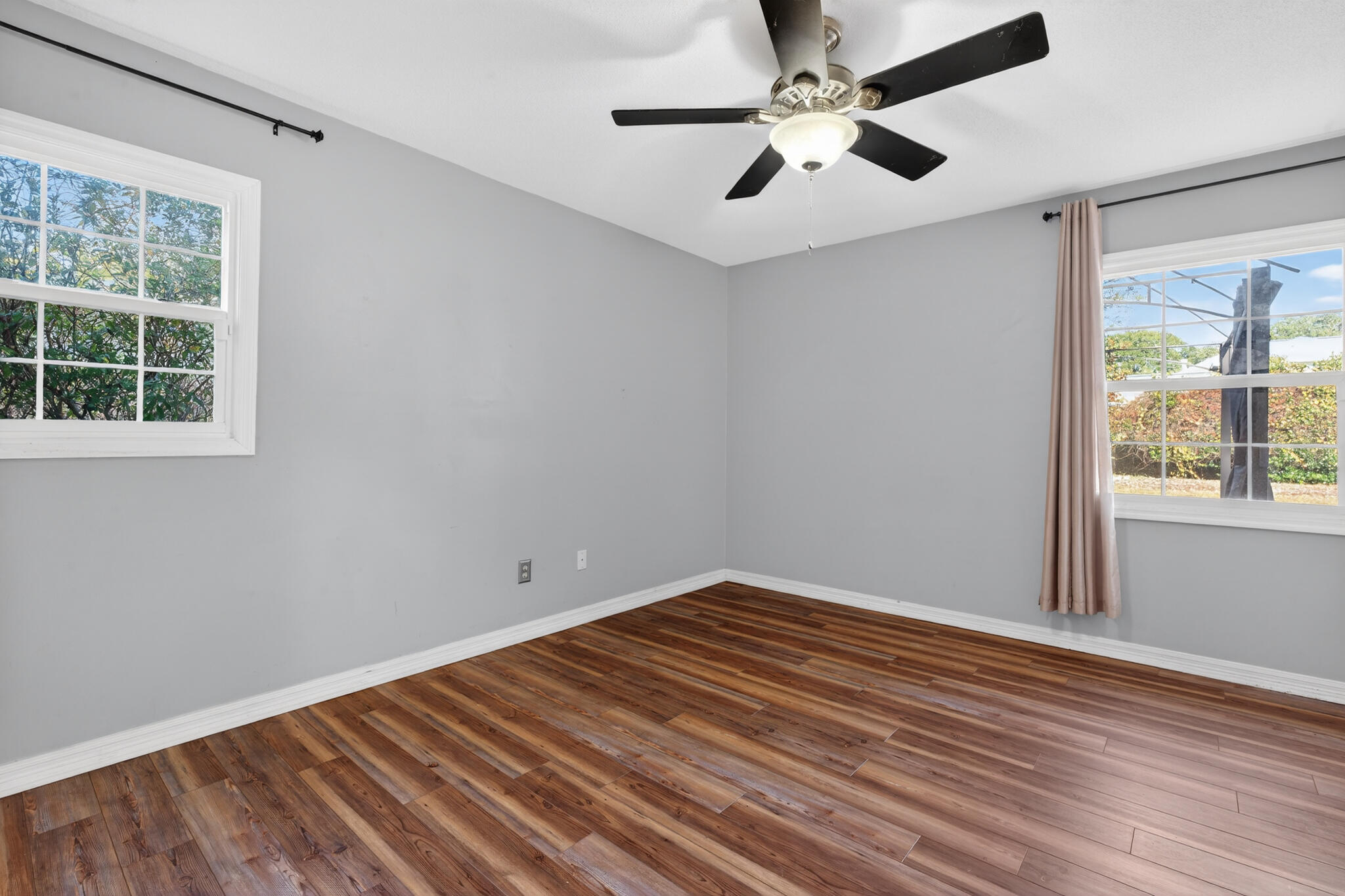 9 Walnut Avenue Shalimar, FL 32579 - Photo 20 of 61 a view of an empty room with wooden floor and a window