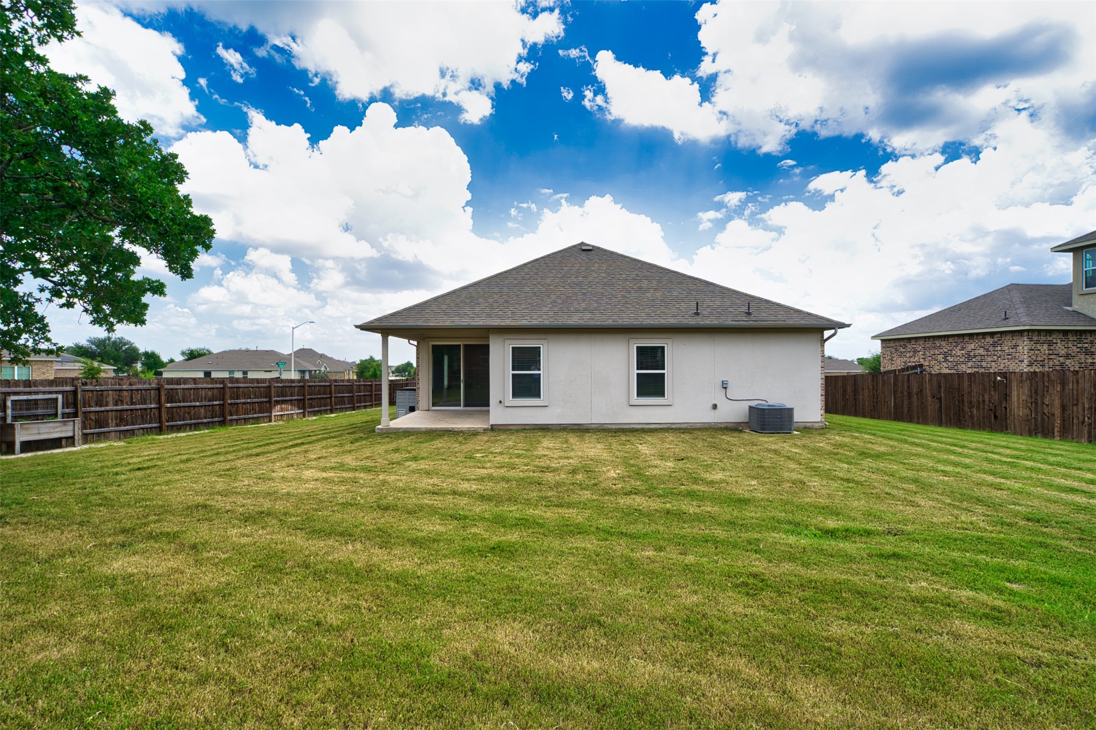 4125 Buffalo Ford Road Georgetown, TX 78628 - Photo 26 of 28 Back of property featuring a fenced backyard, a patio, stucco siding, and roof with shingles