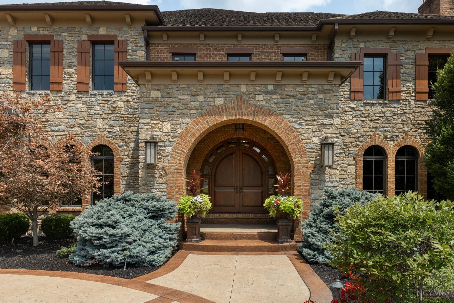 5900 Park Road Cincinnati, OH 45243 - Photo 3 of 50 The Tuscan style embraces classical architectural elements with an ornate flair. The arched stone and brick yields to a covered front entry (16’ X 6’) and this massive entry door.
