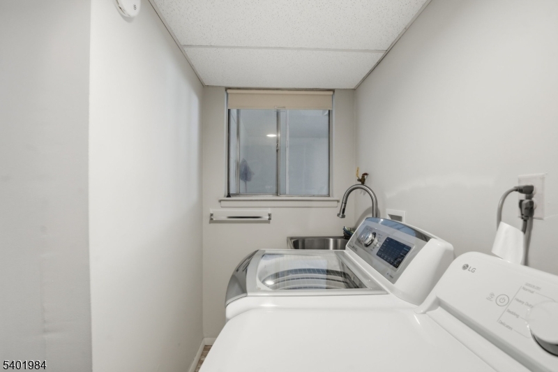 95 Martin Road Livingston, NJ 07039 - Photo 11 of 26 a bathroom with a sink and mirror