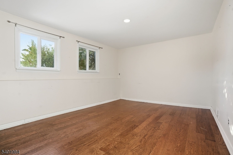 95 Martin Road Livingston, NJ 07039 - Photo 14 of 26 a view of an empty room with wooden floor and a window