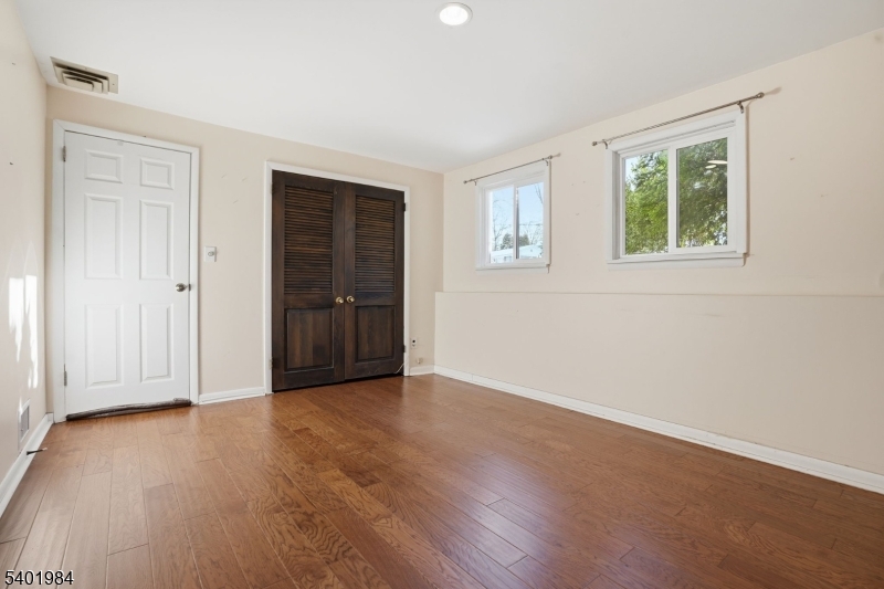 95 Martin Road Livingston, NJ 07039 - Photo 15 of 26 an empty room with wooden floor and windows