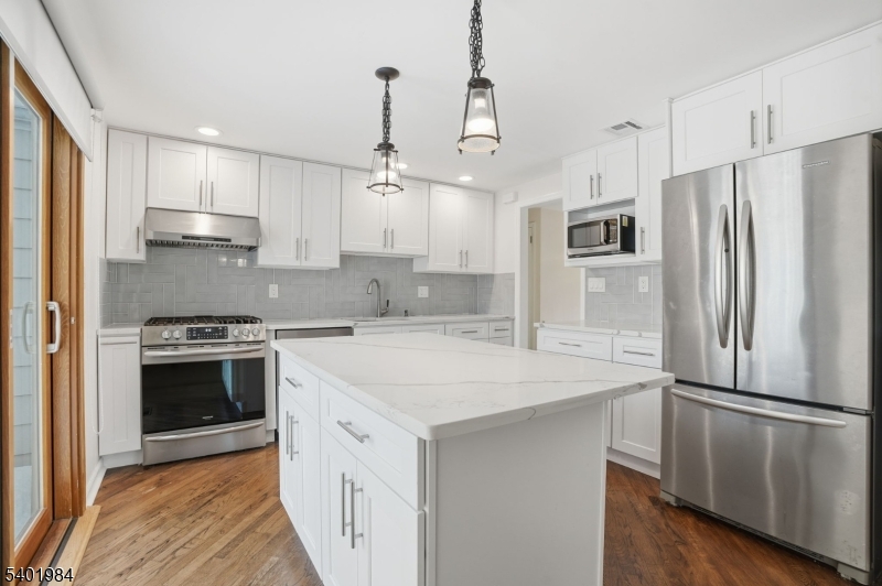 95 Martin Road Livingston, NJ 07039 - Photo 6 of 26 a kitchen with stainless steel appliances a refrigerator sink and stove
