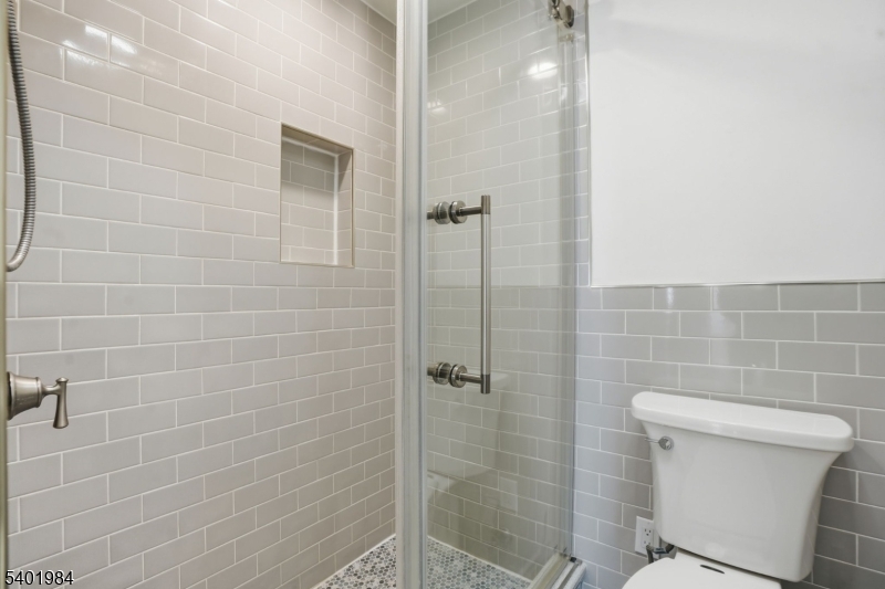 95 Martin Road Livingston, NJ 07039 - Photo 7 of 26 a bathroom with a shower and toilet